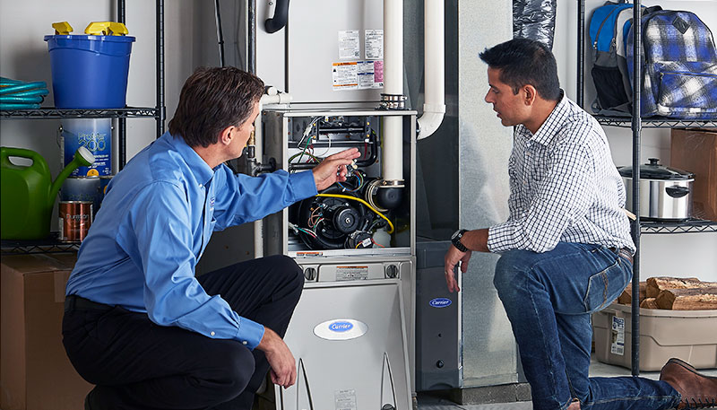 HVAC technician evaluating a furnace for repair or replacement in Brigham City