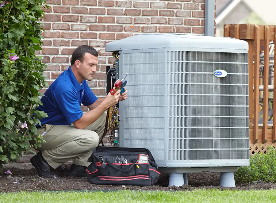 HVAC technician inspecting an outdoor air conditioning unit in Brigham City
